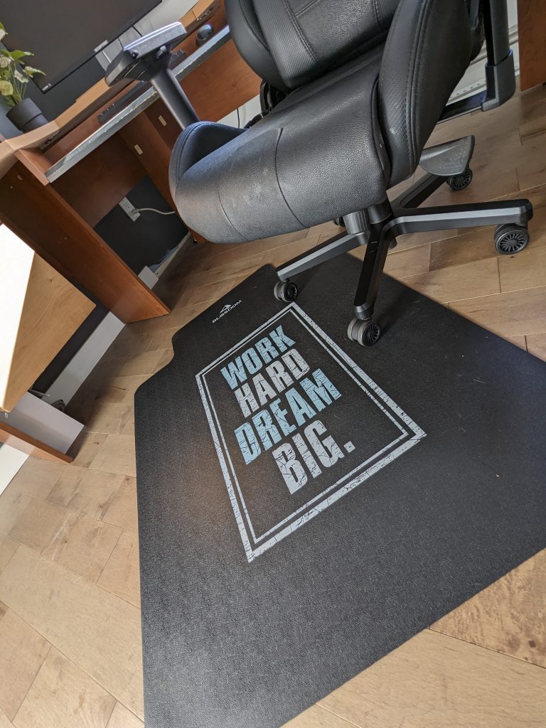 A black office chair mat with beautiful motivational graphic