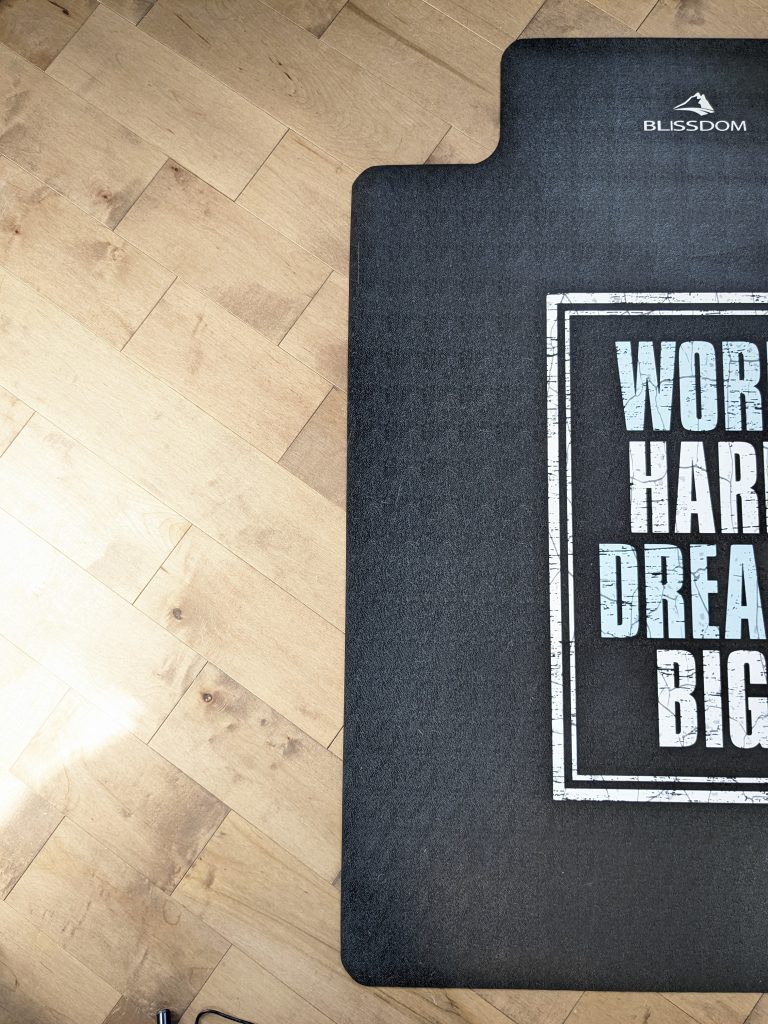 A black office floor protector mat with a beautiful motivational graphic